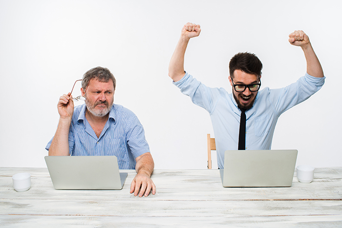 two-colleagues-working-together-office-white-background_700x467